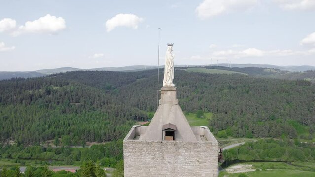 Shrine To The Virgin Mary At Chateau de Luc In Lozere, France. drone orbiting shot