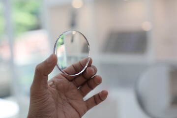 close up of hand holding a magnifying glass