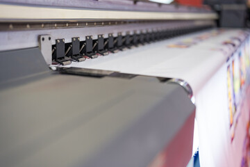 Close-up of large format printer heads in action