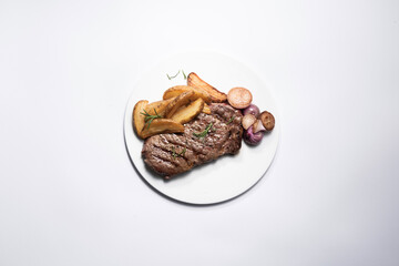 Potato dish and steak on a plate seen from above