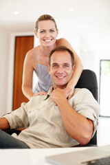 Smile, portrait and couple in hug on chair, love and proud of marriage milestone in home. Happy, embrace and people for relationship achievement, romance and bonding in apartment for enjoyment