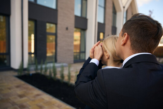 Back View Picture Of Adult Couple Standing Outside House