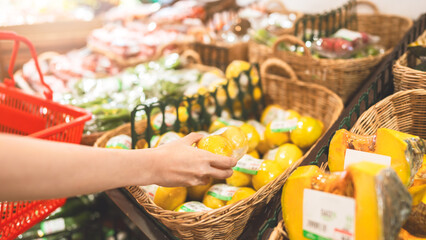 Woman hand consumer choosing organic vegetable product  at supermarket store