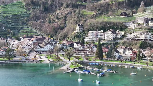 Drone clip moving towards traditional buildings in Weesen, St Gallen, on the lakeside shore of Lake Walen