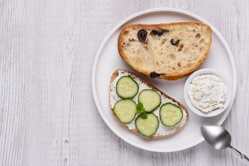 Olive bread with cottage cheese and cucumbers, with copy space for text