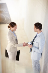 Top view, greeting or business people shaking hands in office for b2b negotiation, success or...