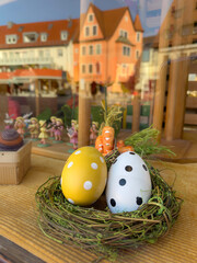 window of a toy shop decorated with for easter with colorful eggs