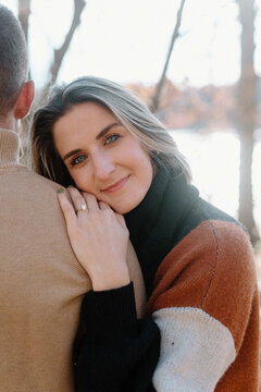 Newly engaged woman smiling, showing diamond engagement ring