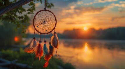 Beautiful handmade dream catcher near the river at sunset. Space for text ,Beautiful handmade dream catcher near river at sunset,A dream catcher, hanging from a twig, with the evening sun
 - obrazy, fototapety, plakaty