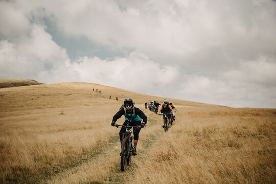 Group of young people exploring nature with e-bikes
