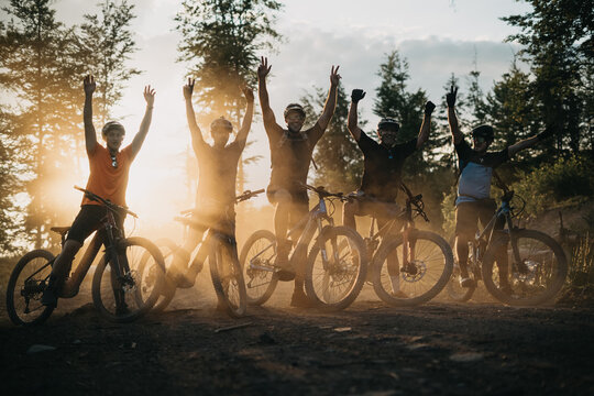 Happy Young People Posing with Their E-Bikes during  Sunset