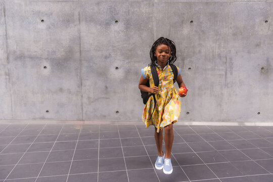 African American girl walking to class - Powered by Adobe