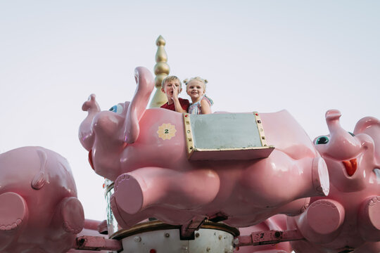 Kids on elephant carnival ride at county fair