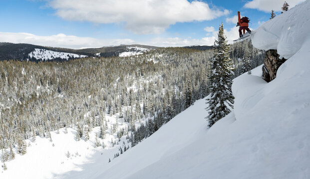 Man snowboarding at snowcapped mountain during vacation