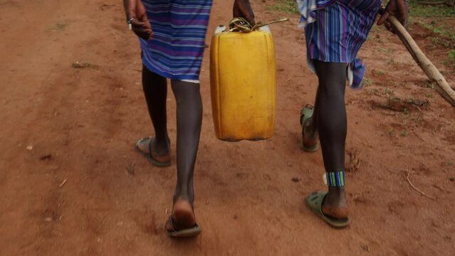 Men Walking with a Jerrycan