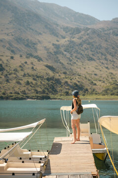 Tourist admiring Lake Kournas on the island of Crete from boat dock