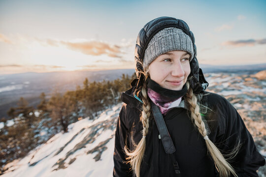 Woman hiking in winter cold at summit of Borestone Mountain