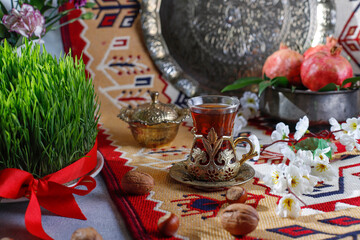 Traditional Azerbaijan holiday Novruz background with green semeni,traditional azerbaijan sweets,shekerbura,qogal,paxlava,mutaki and different nuts and sweets,top view,space for copy
