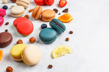 Colorful french dessert macarons with fresh fruits and nuts.