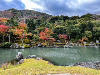 Autumn landscape in Kyoto. Mesmerising view at the lake with colourful trees on the background....