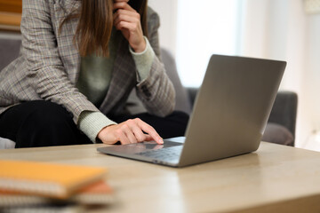 Cropped shot of businesswoman working at home checking business email on her laptop