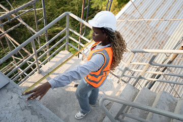 Worker engineer African woman working with caucasian worker at construction site	 - 770400634