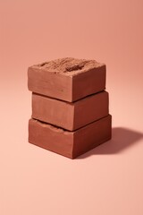 Chocolate stack on plain coloured background.