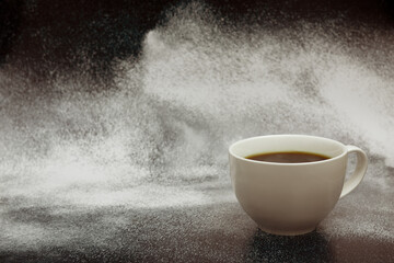 A cup of coffee against a background of splashes. Coffee and space for text. Lifestyle with a cup of coffee.