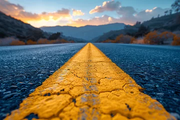 Poster Photo of empty asphalt road with yellow dividing strip in the middle against sunset background. View from the yellow stripe © CozyDigital