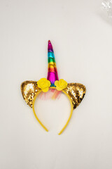 A yellow unicorn children's headband on the table