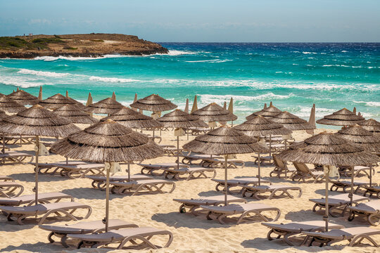Solar straw canopies on Nissi beach in Aiya Napa, Cyprus.