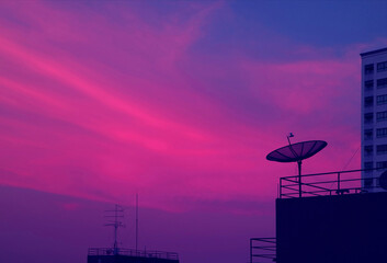 Pop Art of Vibrant Blue and Purple Tone Satellite Dish on the High Building Against Evening Sky