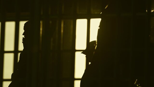 Passengers following to ferry in front of sunset - silhouette