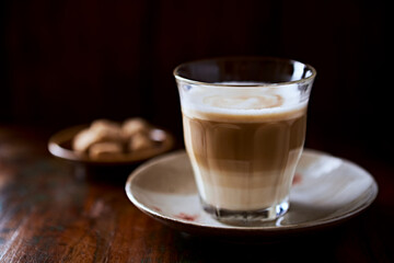 Coffee with milk on rustic wooden background. Soft focus. Close up. Copy space.	