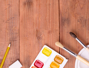 School and painter accessories on wooden table