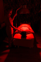 A patient experiences soothing infrared therapy under a therapist's care.