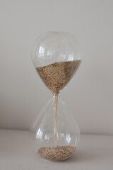 hourglass with gold in white studio
