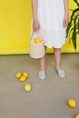 lemons in a basket in a studio with white background