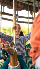 Boy riding a carousel in an amusement park