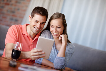 Couple, relax and happy in home with tablet for streaming online for movies or films, videos and...