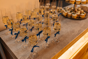 glasses with white champagne on table for guests of the event, out catering