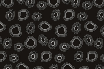 Seamless pattern. White concentric circles of irregular shape on a black background. Flyer background design, advertising background, fabric, clothing, texture, textile pattern.