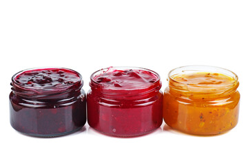Three colored jam in glass jare isolated on a white background