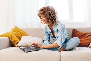 Smiling woman working on laptop at home, a modern freelance lifestyle