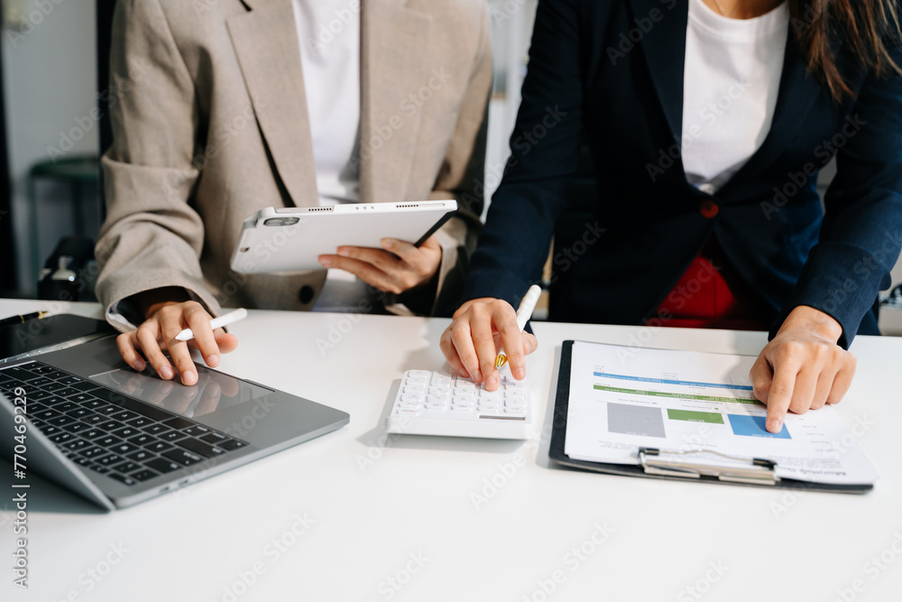 Poster business documents on office table with smart phone and calculator digital tablet and graph business