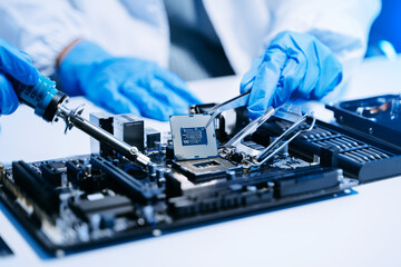 The technician is putting the CPU on the socket of the computer motherboard. electronic engineering electronic repair, electronics measuring.