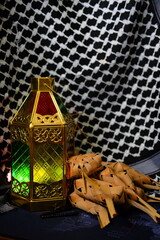 stained glass lamps and ketupat against the background of keffiyeh cloth