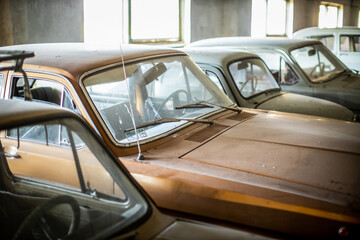 old rusted vintage car collection in barn