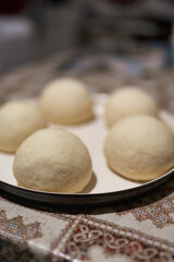 Balls of dough for pizza and bread in home kitchen