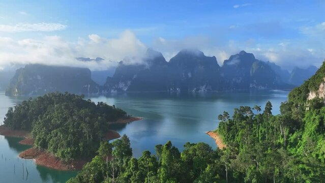 The green area at Khao Sok national park Cheow Lan Dam lake with blue sky background in Surat Thani, Thailand	